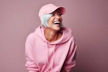 Portrait of a beautiful woman in pink hoodie and cap.