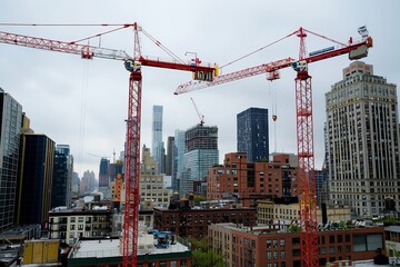 Construction cranes towering over a cityscape, symbolizing progress and development in urban environments, Generative AI