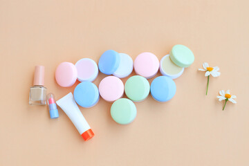 Cosmetic bottle containers with White flower, isolated on beige background, Beauty products