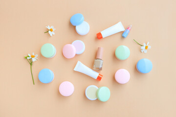 Cosmetic bottle containers with White flower, isolated on beige background, Beauty products