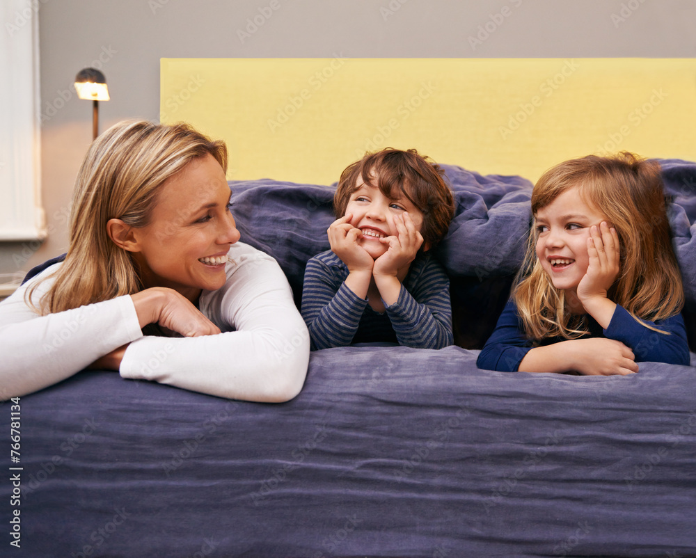 Wall mural Home, mother and kids in bed with love, support and bonding together with a smile. Happy, family and children with mom in the morning in the bedroom relax with youth in a house with parenting