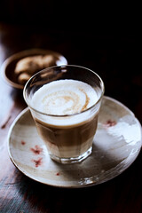 Coffee with milk on rustic wooden background. Soft focus. Close up. Copy space.	