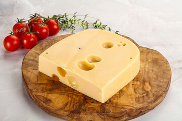 Maasdam cheese brick over board