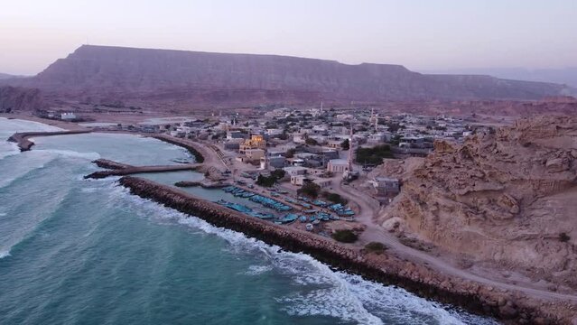Twilight landscape pink blue sky horizon mountain background wonderful beach town wide view aerial shot fly over seaside rural countryside Iran Qatar travel destination tasty food local people culture