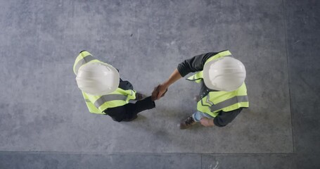 Top view of engineering, handshake or men in architecture project, property development or partnership. Greeting, teamwork or contractor in construction deal shaking hands for meeting collaboration