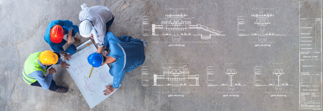Electric Train Section drawing for construction, top view of architectural engineer working on his blueprints with documents on construction site. meeting, discussing,designing, planing