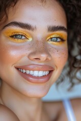 Woman smiling with yellow eyeshadow. Bright and cheerful portrait of a woman with yellow eyeshadow and a beaming smile