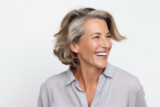 Portrait of happy mature businesswoman laughing and looking at camera.