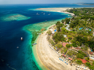 Aerial view of a tropical beach resort next to a coral reef on a small island (Gili Air, Indonesia)