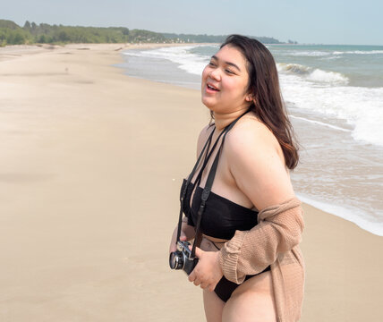 Portrait young woman asian chubby cute beautiful oneperson in bikini black sexy front viewpoint tropical sea beach white sand clean and bluesky background calm Nature ocean Beautiful wave water travel