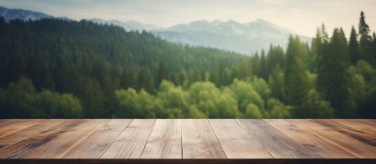 An empty wooden table surrounded by a natural landscape with a forest, grass, and trees in the...