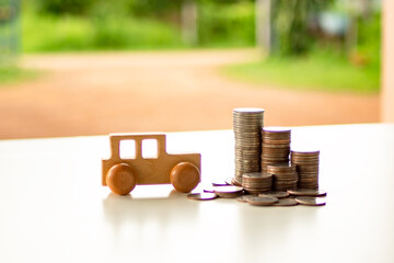 Car wooden model with with coins stack on table. Asset approval concepts purchases to buy a car and a house. Ideas for home buying checklist home loan tax.	