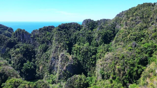 Primeval jungle hills island phi phi island. Fantastic aerial top view flight rotation to left drone
4k