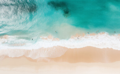 Fototapeta na wymiar Overhead shot of a beach as people swim in the water, enjoying a sunny day by the sea