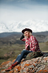 Portrait girl traveler with hat and mug on background of mountains - 766808308