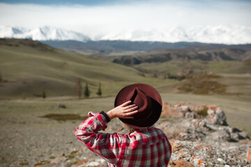 Girl traveler with hat on background of mountains - 766808321