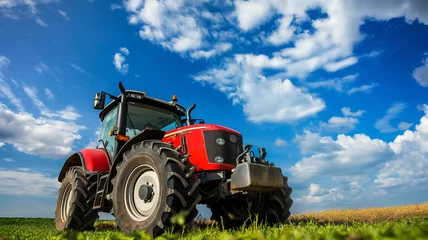 Foto op Aluminium Farm tractor in the field under blue sky with white clouds © kanurism