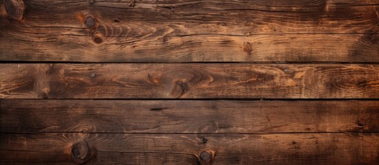 Detailed view showing the texture of a wooden wall that has been stained with a warm brown color
