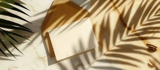 Rolgordijnen Summer-themed mock-up scene with blank greeting card and craft envelope under sunset lighting, featuring a date palm leaf shadow overlay on a golden marble table background. Presented in a flat lay, © Vusal