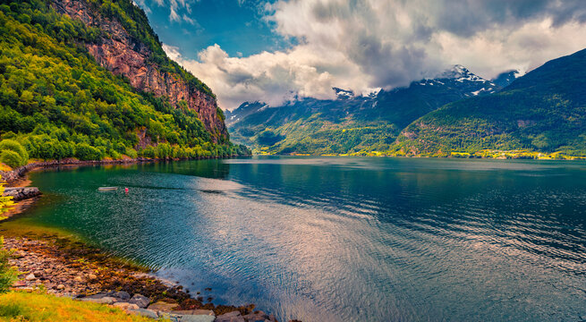 Impressive summer view of Hardanger fjord with green forest on canyon wall. Stunning morning scene of Hordaland county, Norway, Euripe. Beauty of countryside concept background.