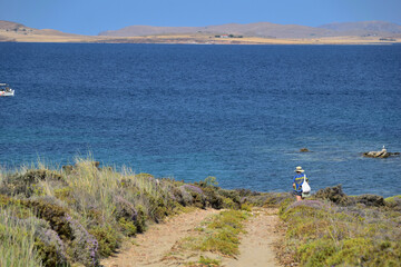 seascape with a woman on a path, at sea coast - Fanaraki area, near Moudros, Lemnos, Aegean Sea, Greece