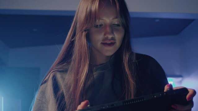 a young girl is playing a video game on a nintendo switch