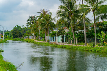 Houses on the river bank.
A small river flowing through the village. Central highlands of Vietnam.