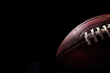 American football ball on dark background with space for text