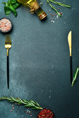 Kitchen banner. Cutlery, vegetables and spices on a dark stone table. free space for text.