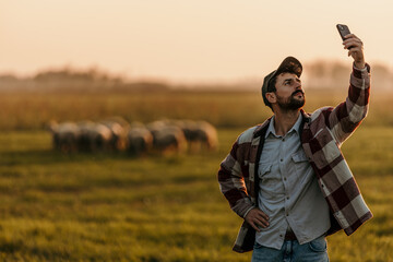 Farmer seeks a signal amidst the beauty of a rural sunset