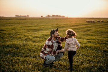  Farmer and his little girl enjoying the tranquility of their rural land at dusk