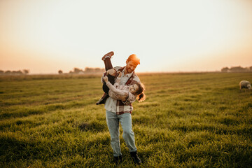Farmer dad and daughter sharing a tender embrace amidst the golden glow of sunset