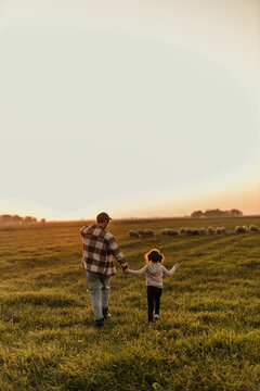  Farmer and his little girl enjoying the tranquility of their rural land at dusk