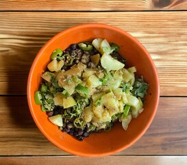 kala Chana masala chaat is the Desi version of a salad black chickpeas, chop onions, chop Cucumber lemon coriander leaves close up isolated on black background