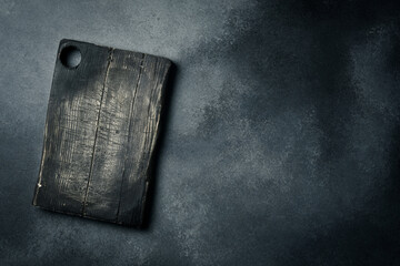 Old Chopping Board on Gray Concrete Background. Creative photo, free space for text.