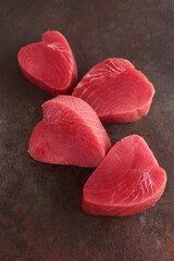 Fresh tuna. Tuna steak. A useful omega. Pieces of fresh fish. Vertical photo.
