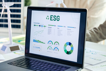 ESG ( environment, social,governance) recycle sign on laptop screen with carbon free chart board in office - 766857332