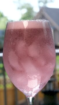 Filling a Glass with Cold, Sweet, Acidulated, and Refreshing Grapefruit Drink. A Glass Full with Tasty Fresh Drink. High quality 4k footage