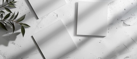 Business card mockups in white color placed diagonally on a light grey concrete background with soft shadows. Top view with an open composition.