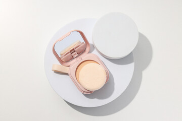 Face powder, light shade on a light background.