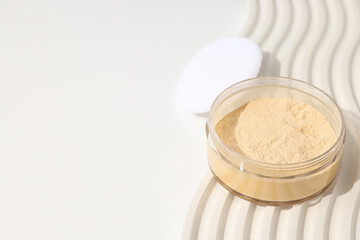 Face powder, light shade on a light background.