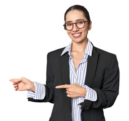 Confident young Caucasian businesswoman on studio background excited pointing with forefingers away.