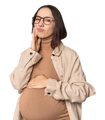 Pregnant young Caucasian woman showcasing maternity on studio background having a strong teeth pain, molar ache.