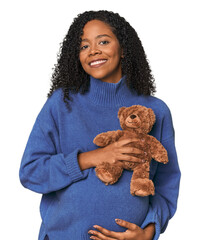 Expectant African American woman with teddy bear