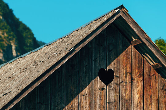 Heart-shaped pigeon hole on wooden farm shed, detail from Bohinj region in Slovenia