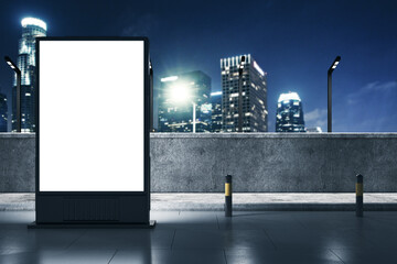 Illuminated empty billboard mockup on a city rooftop at night. Urban advertising concept. 3D...