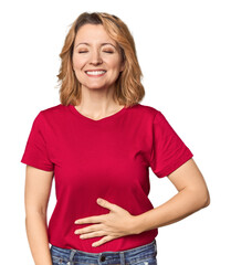 Blonde middle-aged Caucasian woman in studio touches tummy, smiles gently, eating and satisfaction...