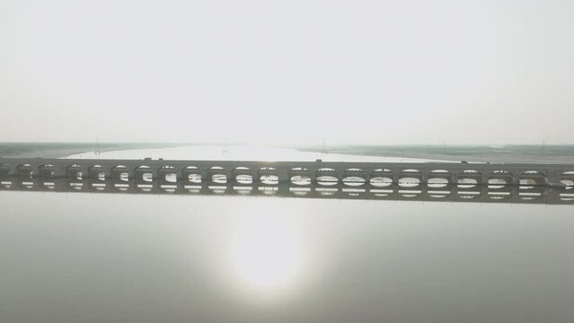A drone moves towards the Sukkur Barrage, capturing its grand scale and the engineering behind the controlled flow of water in Sindh.