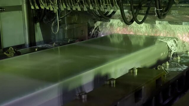 Aluminium sheet rolling in a automated machine. Aluminum sheet is cleaned on an automatic machine.