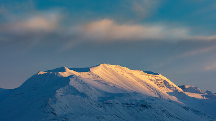 Winter in Iceland; sunset over snow covered mountains